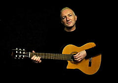 A photo of Ian M Lindsay with a Spanish Flemenco 				Guitar